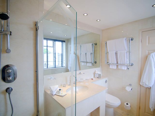 Bathroom with shower, sink and robe in the Beaufort Hotel
